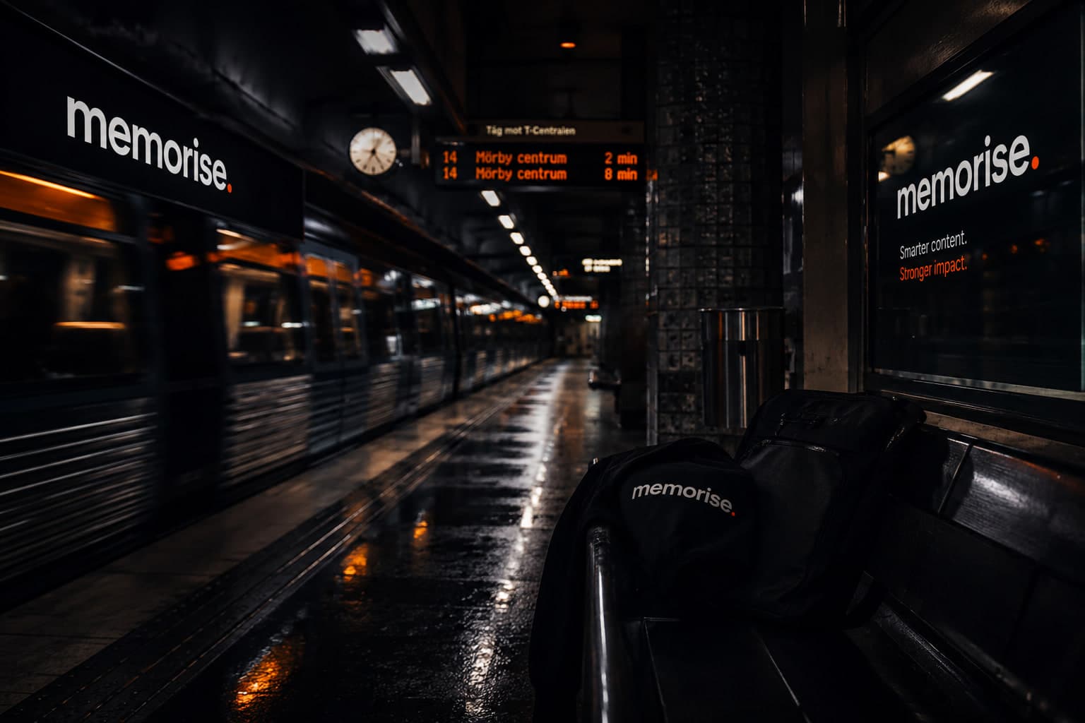 Memorise-branded backpack and clothing on subway platform with train in motion