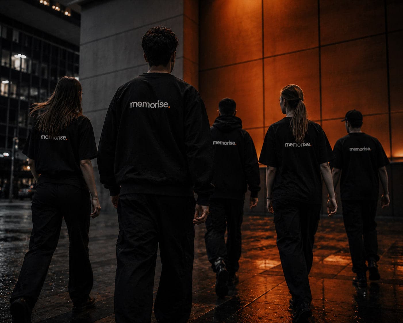 SEO team from Memorise in dark office setting with branded hoodies and caps