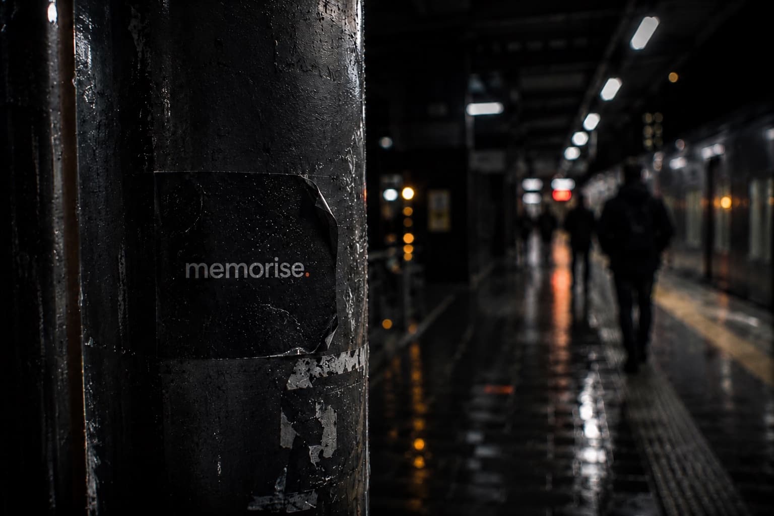 Memorise sticker on subway platform pole with platform and commuters in rainy background